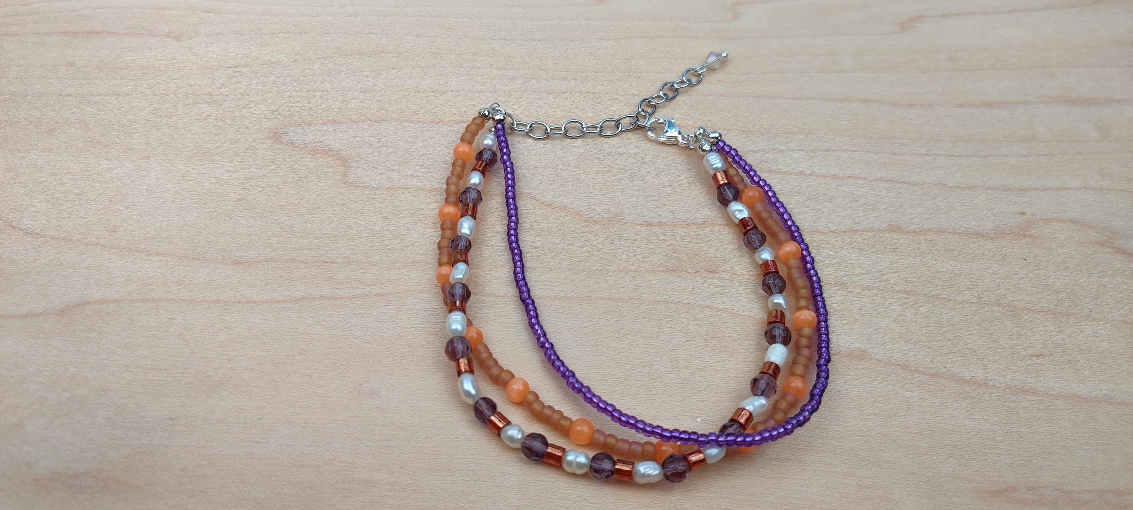 Three Strand Orange, Purple, and Freshwater Pearls Bracelet with Gold, Brown, and Black Glass Beads