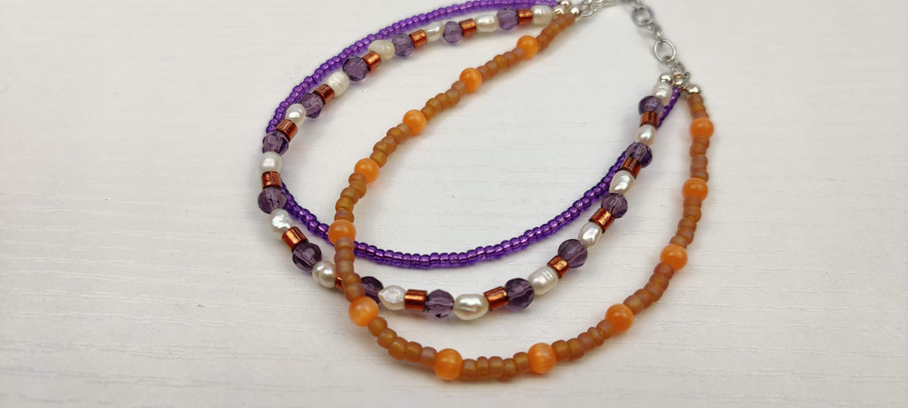 Three Strand Orange, Purple, and Freshwater Pearls Bracelet with Gold, Brown, and Black Glass Beads