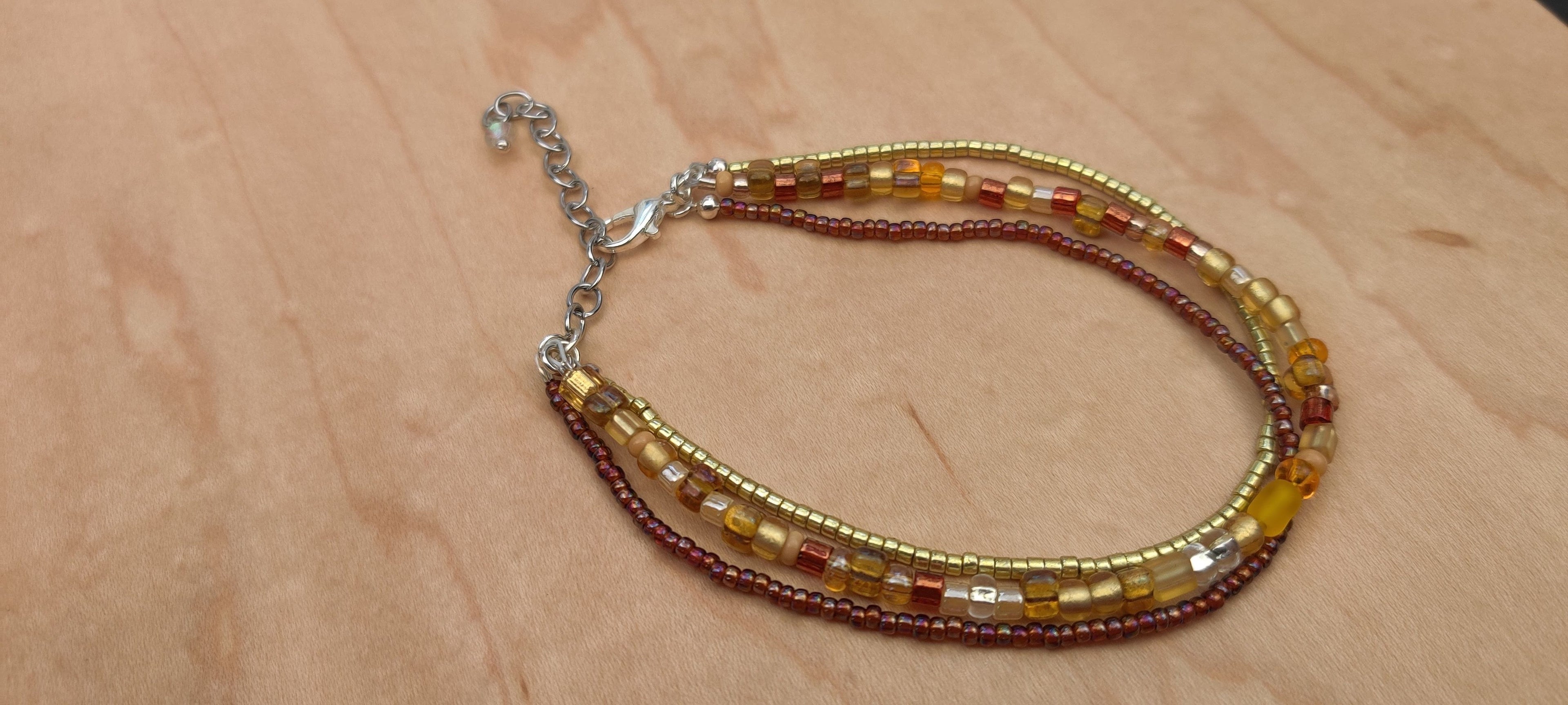 Three Strand Bracelet with Gold, Brown, and Beige Glass Beads
