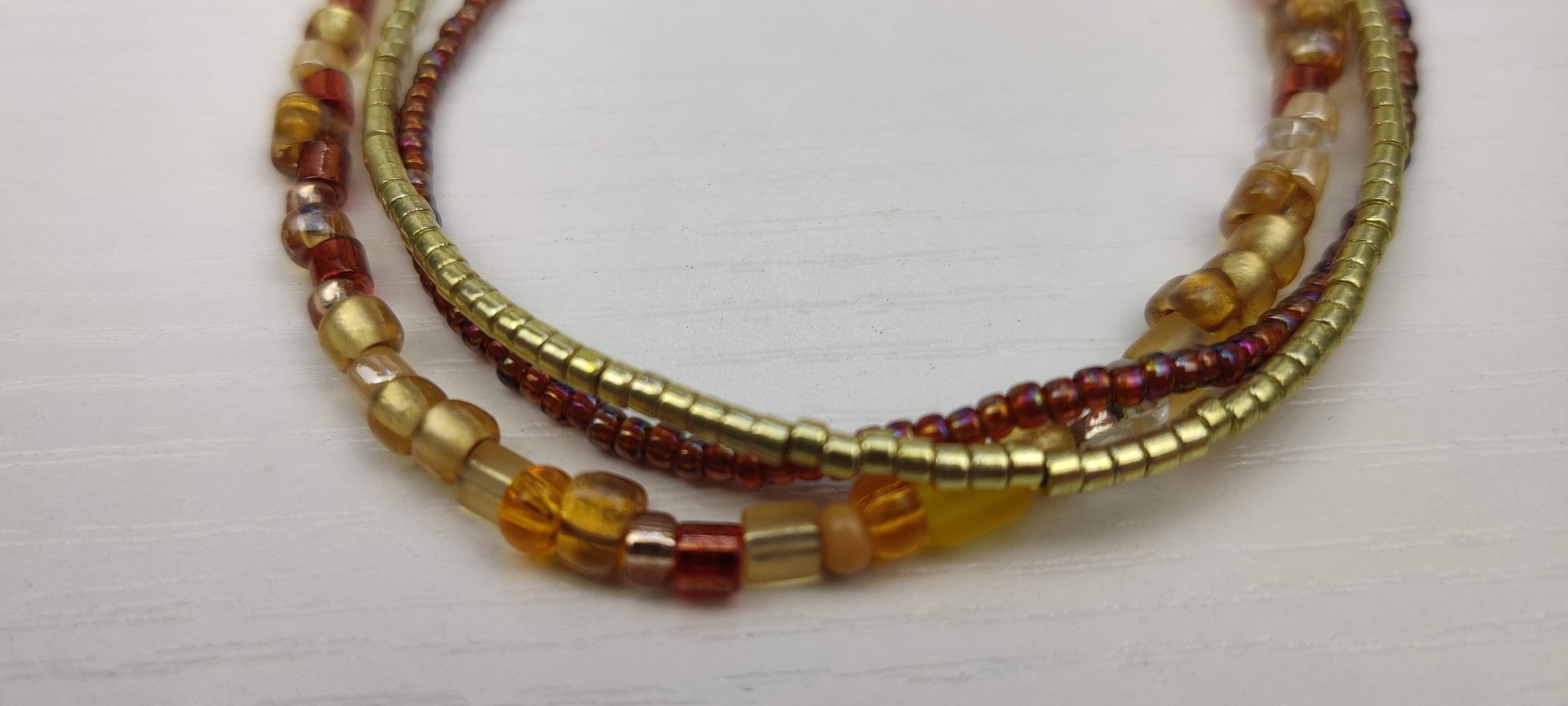 Three Strand Bracelet with Gold, Brown, and Beige Glass Beads