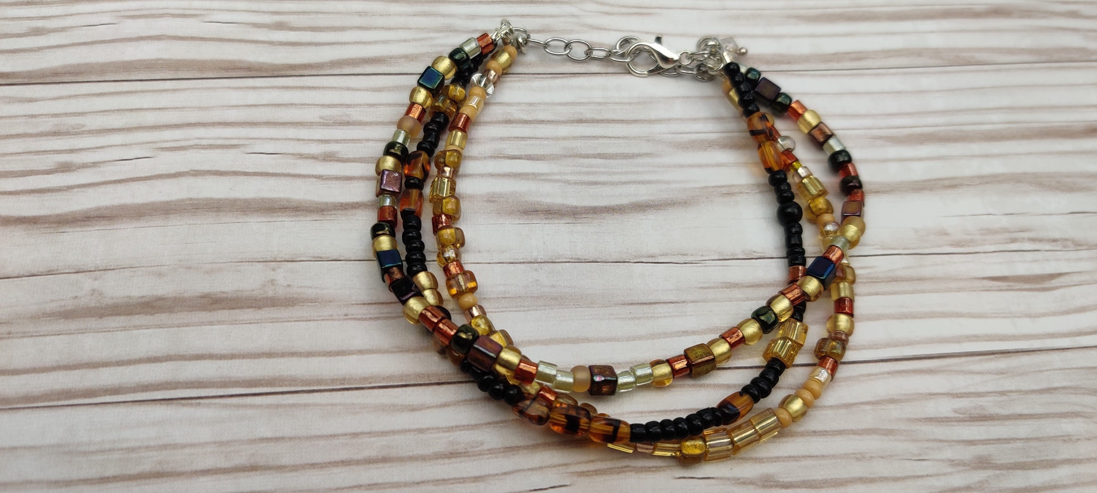 Three Strand Minimalist Bracelet with Gold, Brown, and Black Glass Beads
