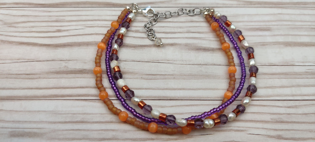 Three Strand Orange, Purple, and Freshwater Pearls Bracelet with Gold, Brown, and Black Glass Beads