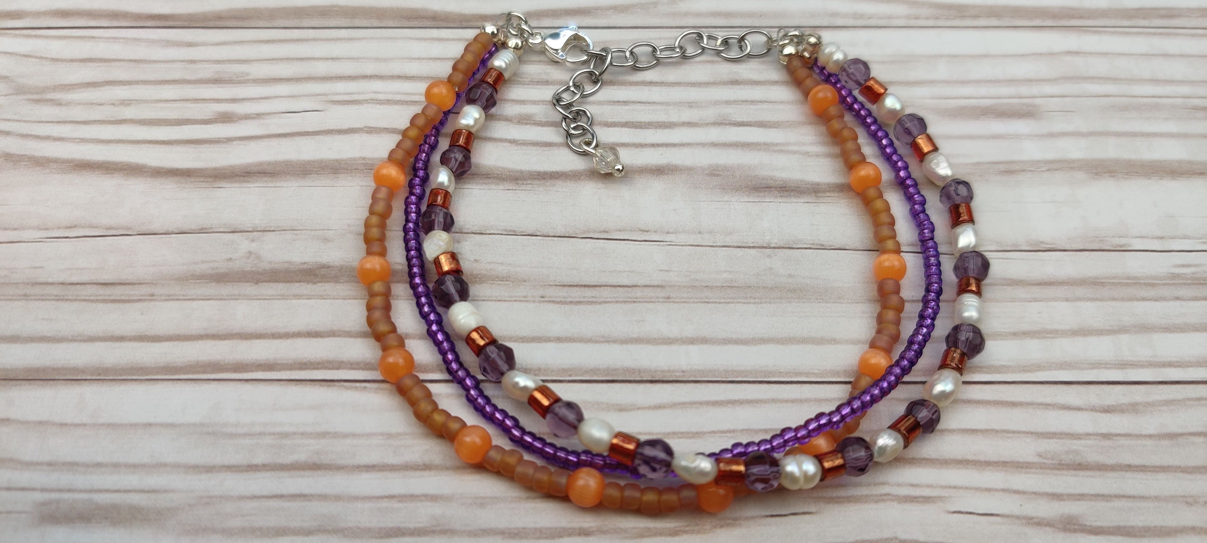 Three Strand Orange, Purple, and Freshwater Pearls Bracelet with Gold, Brown, and Black Glass Beads