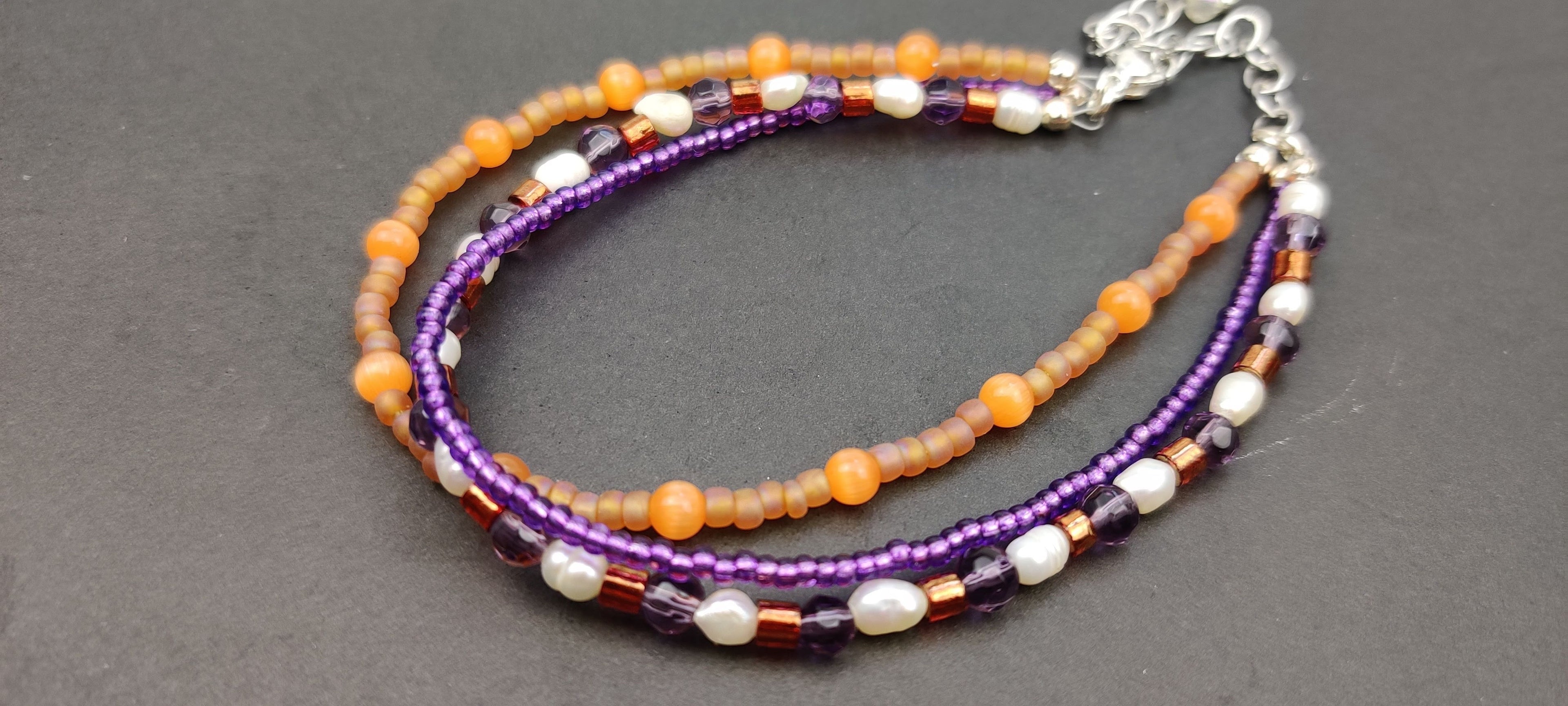 Three Strand Orange, Purple, and Freshwater Pearls Bracelet with Gold, Brown, and Black Glass Beads