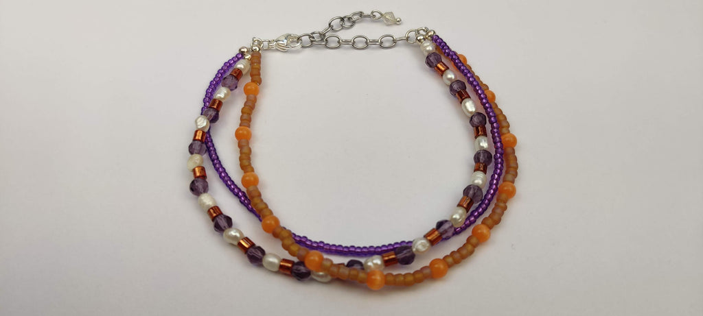 Three Strand Orange, Purple, and Freshwater Pearls Bracelet with Gold, Brown, and Black Glass Beads